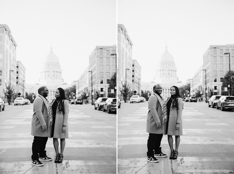 a couple poses in front of the statehouse during their Madison engagement session